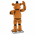 Animatronic stage bear seen from behind on its black metal floor base